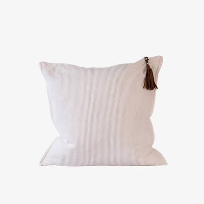 White pillow with a brown tassel on a white background