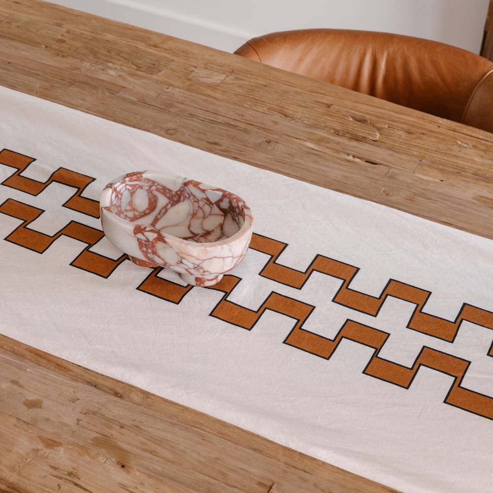 Table runner with geometric pattern on a wooden table