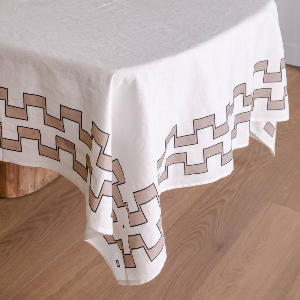 White tablecloth with natural geometric pattern on a wooden floor