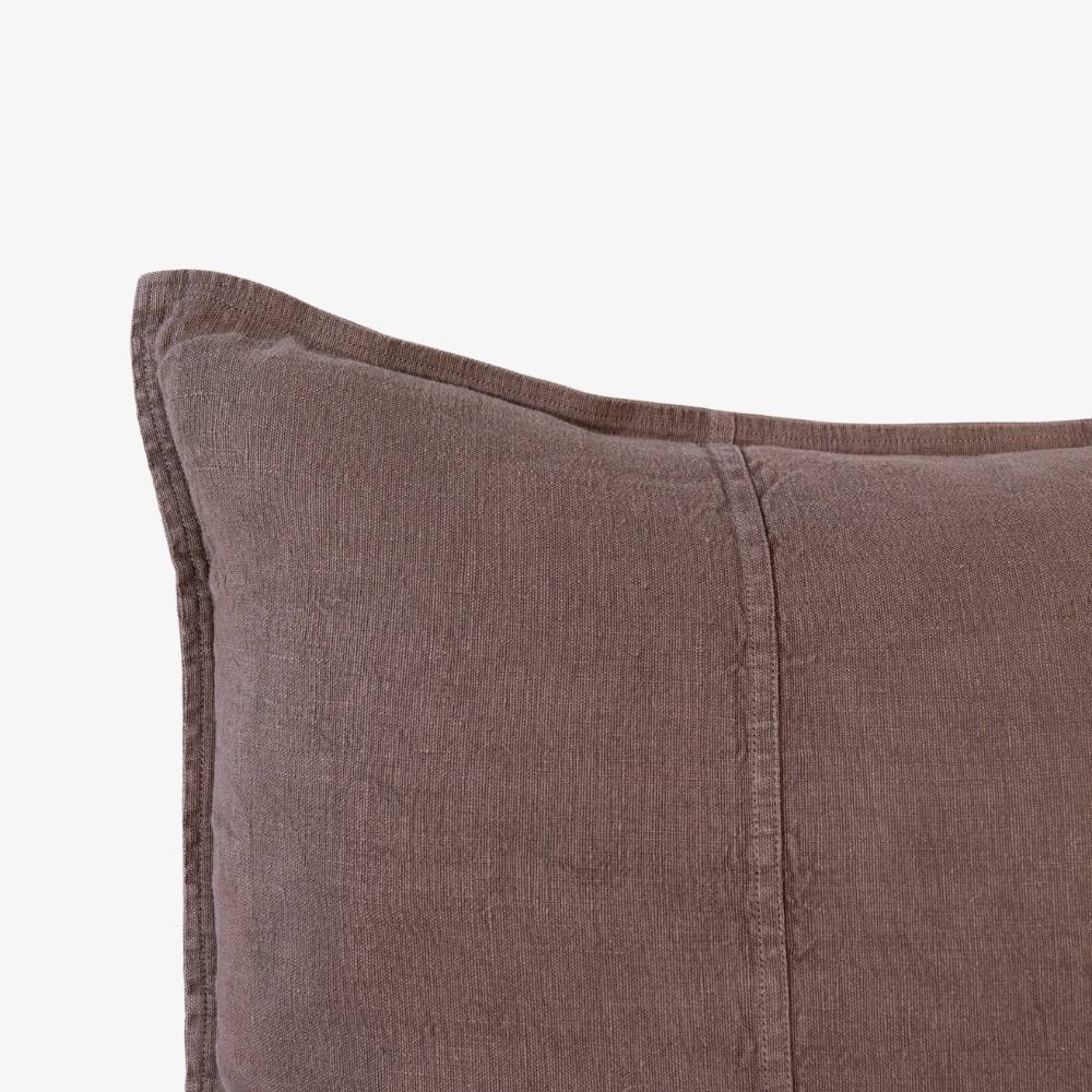 Close-up of a brown textured pillow on a white background