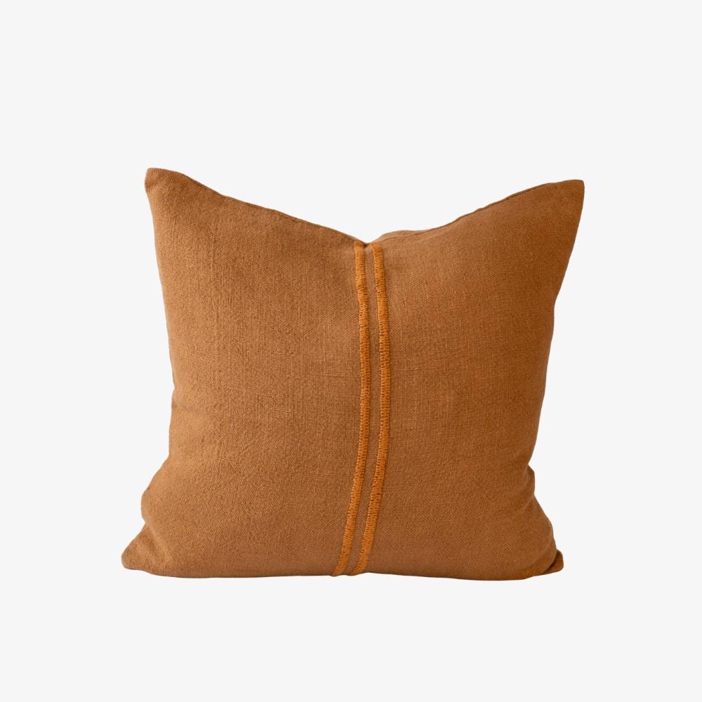Mustard pillow with a central zipper on a white background