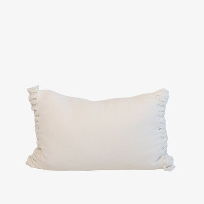 White pillow with fringe detail