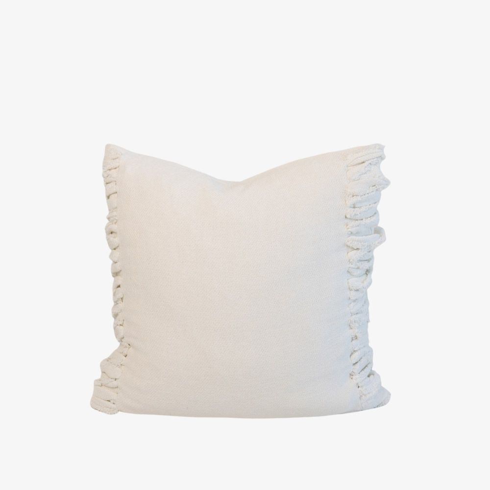 White pillow with fringe detail