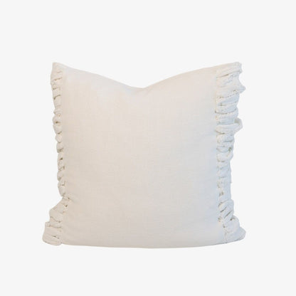 White pillow with fringe detail