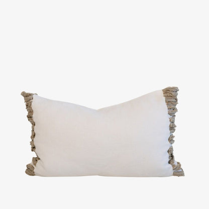 White pillow with beige ruffled edges 