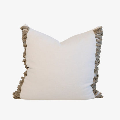 White pillow with beige ruffled edges 