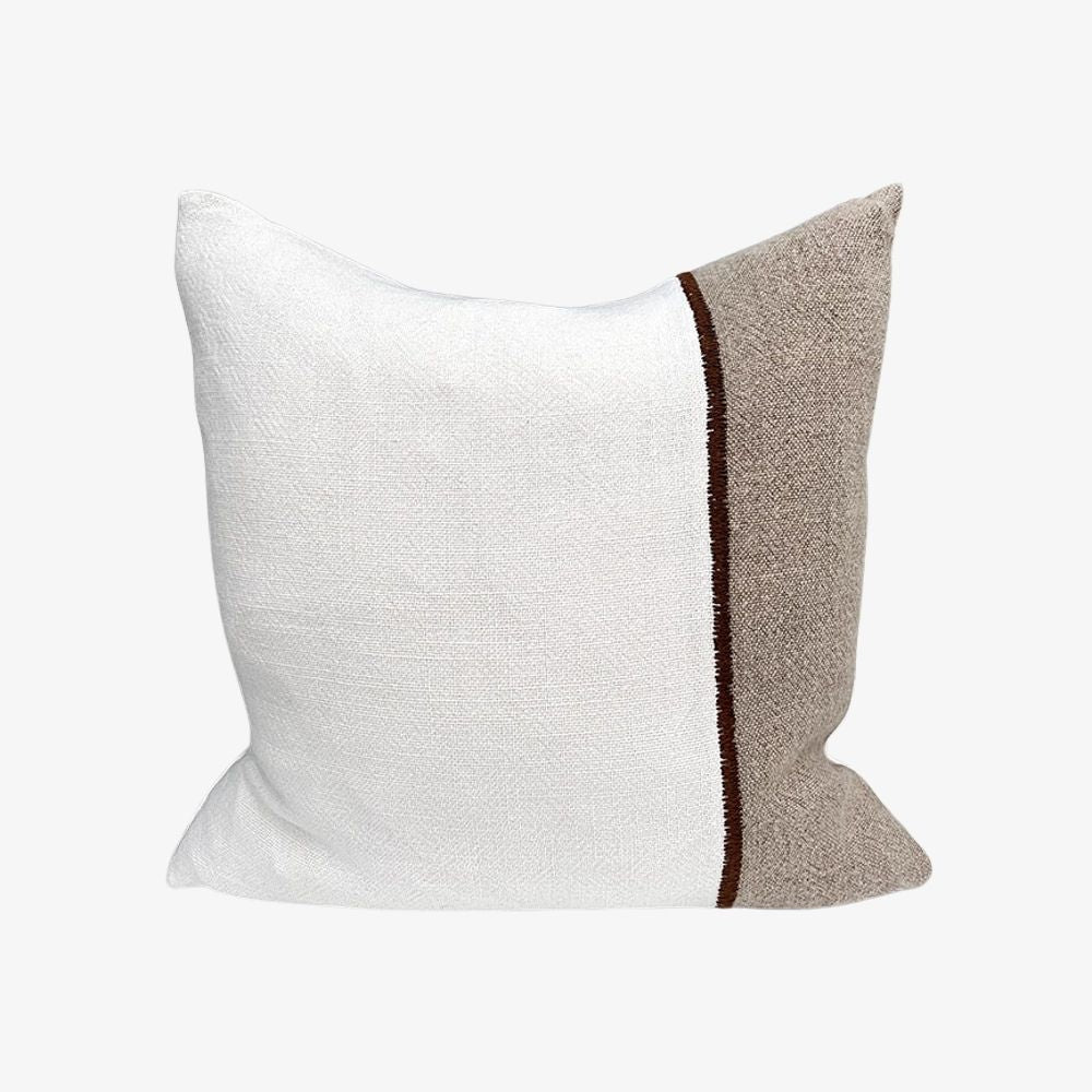 Textured fabric white and grey pillow with a brown stripe 