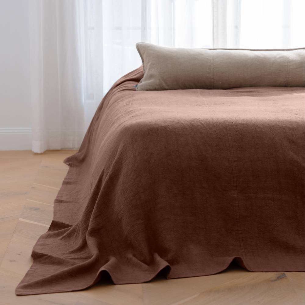 Bed styled with an Eadie linen Luca Bed Cover in Clay colour. Paired with a natural linen long lumbar cushion