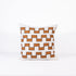 Decorative pillow with 4 lines of brown geometric pattern on a white background