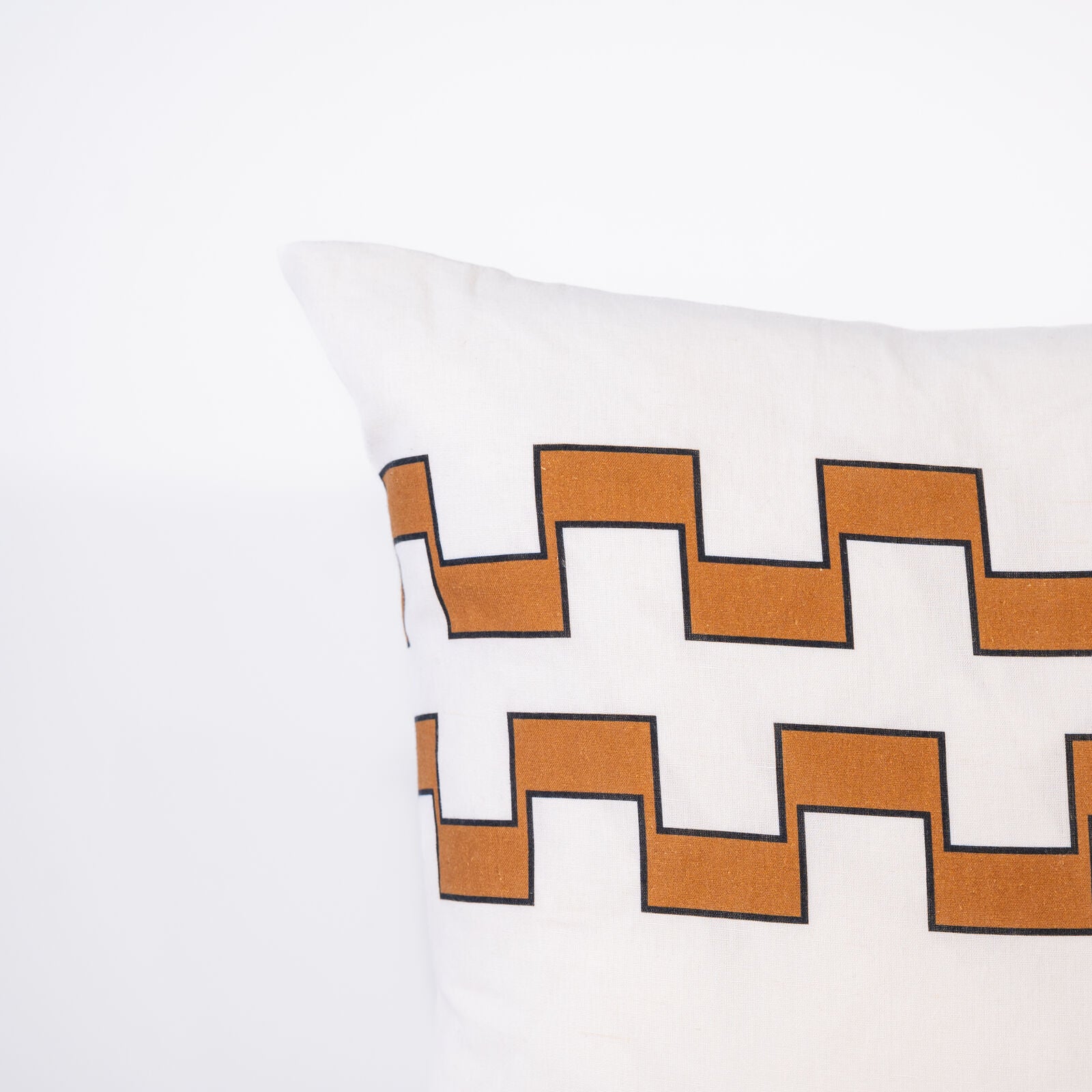 Decorative pillow with 2 lines of brown geometric pattern on a white background