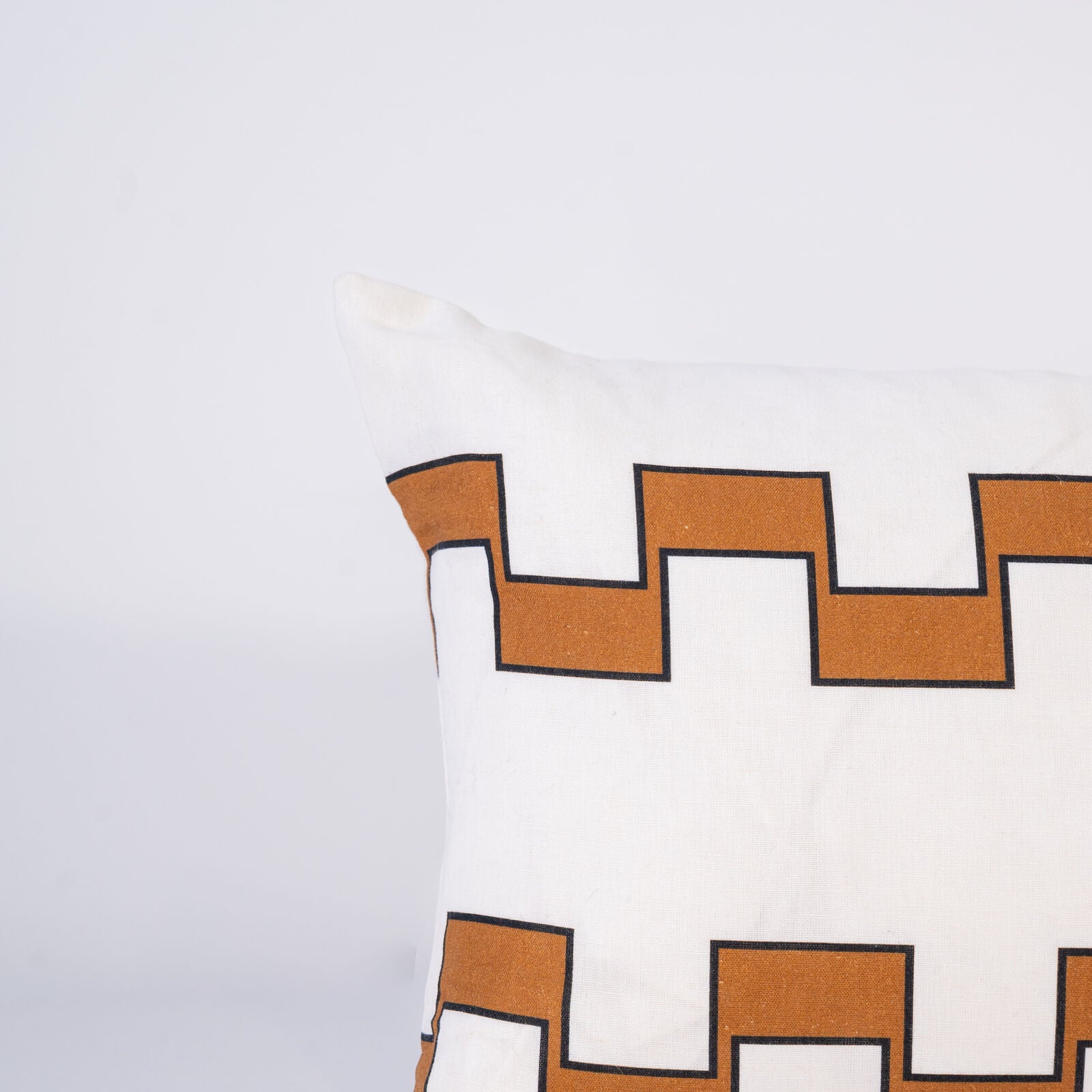 Decorative pillow with 2 lines of beige geometric pattern on a white background