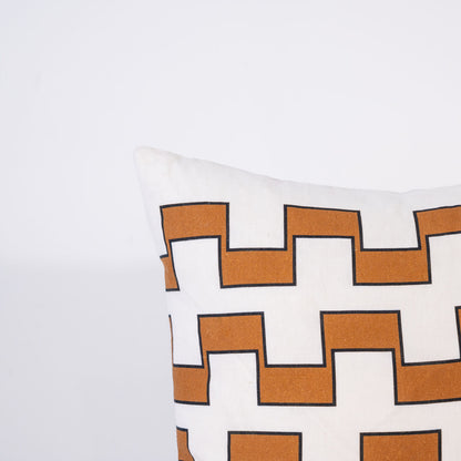Decorative pillow with 3 lines of brown geometric pattern on a white background