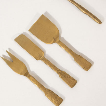 Set of gold cheese tools set on a white background