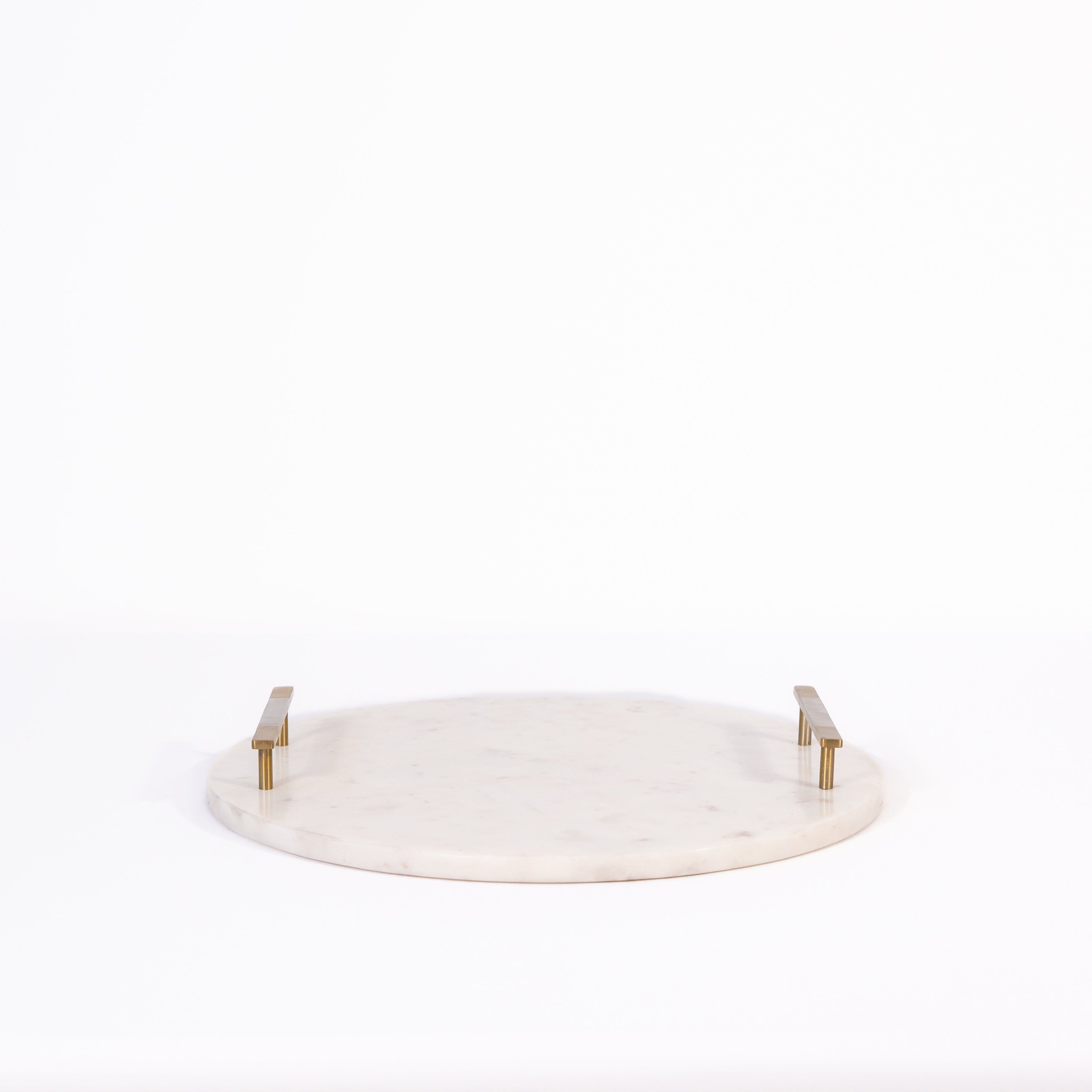 Round white marble cheese tray with gold accents on a white background