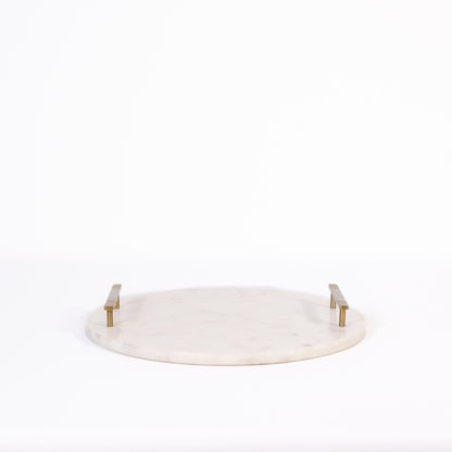 Round white marble cheese tray with gold accents on a white background