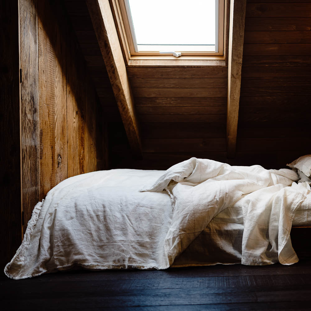 Carter Duvet on bed in Off White with Natural Stripe