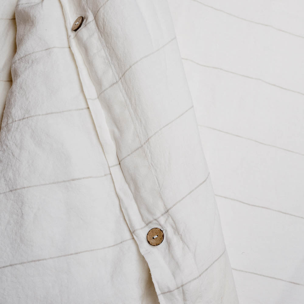 Carter Duvet on bed in Off White with Natural Stripe