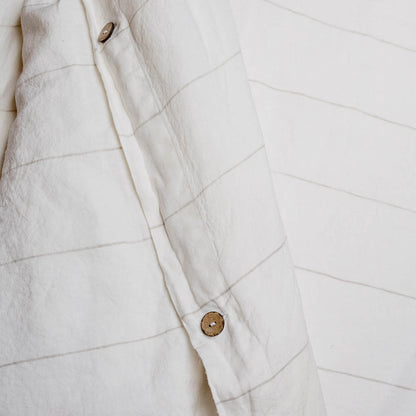 Carter Duvet on bed in Off White with Natural Stripe