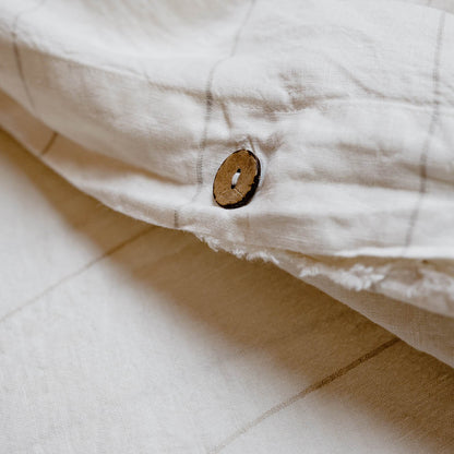 Carter Duvet on bed in Off White with Natural Stripe