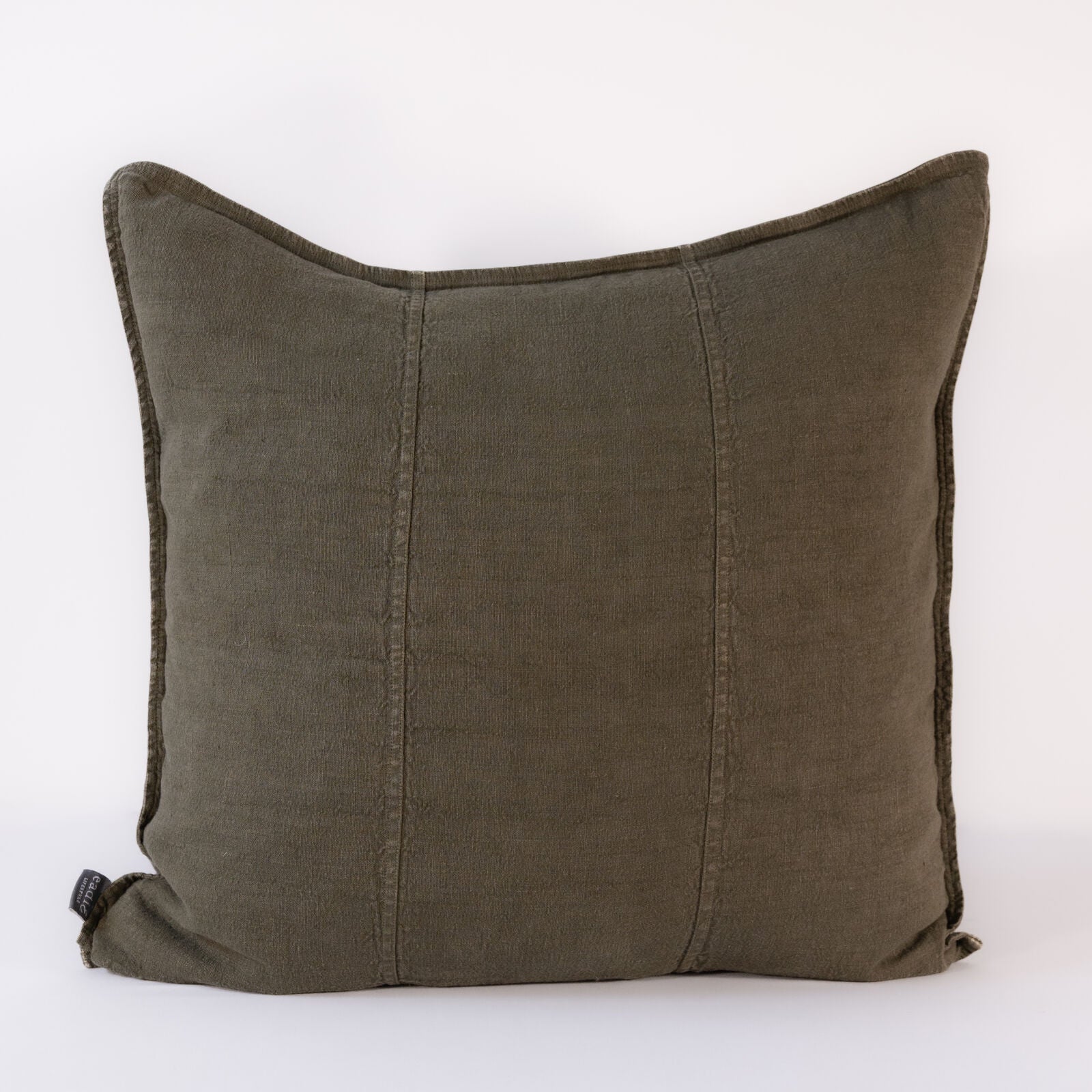 A close-up of a square, textured pillow in a deep, muted olive green color, with subtle vertical stitching details.