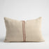A rectangle cushion with natural colour and a stripe in the middle
