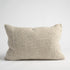A natural green coloured cushion on a white background