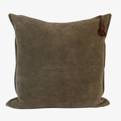 Dark green corduroy pillow with a tassel on a white background