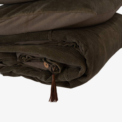 Folded dark green fabric with a button on a white background