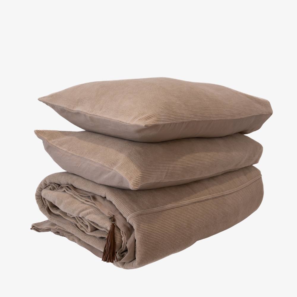Beige textured throw blanket and pillows on a white background