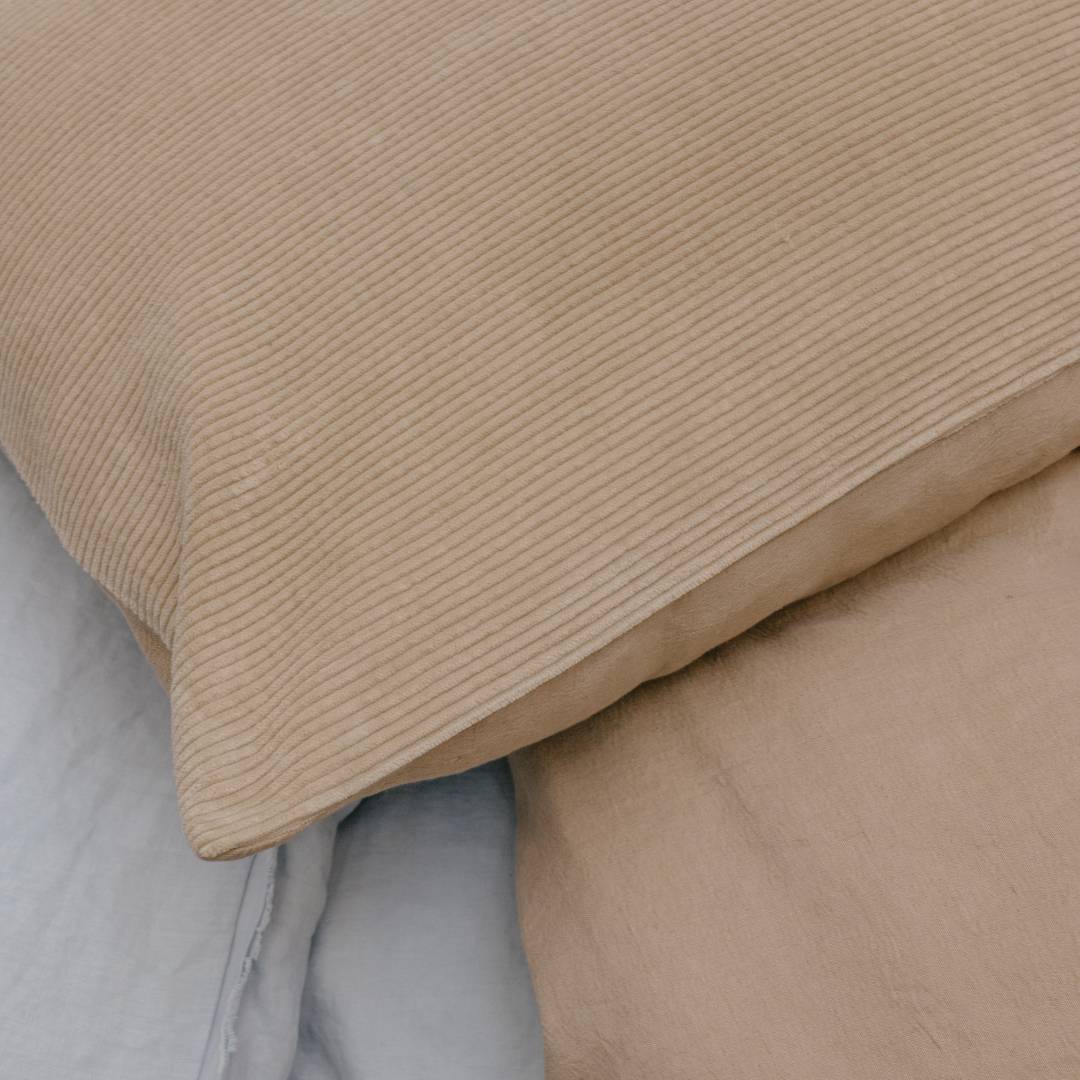 Close-up of beige textured fabric on a neutral background