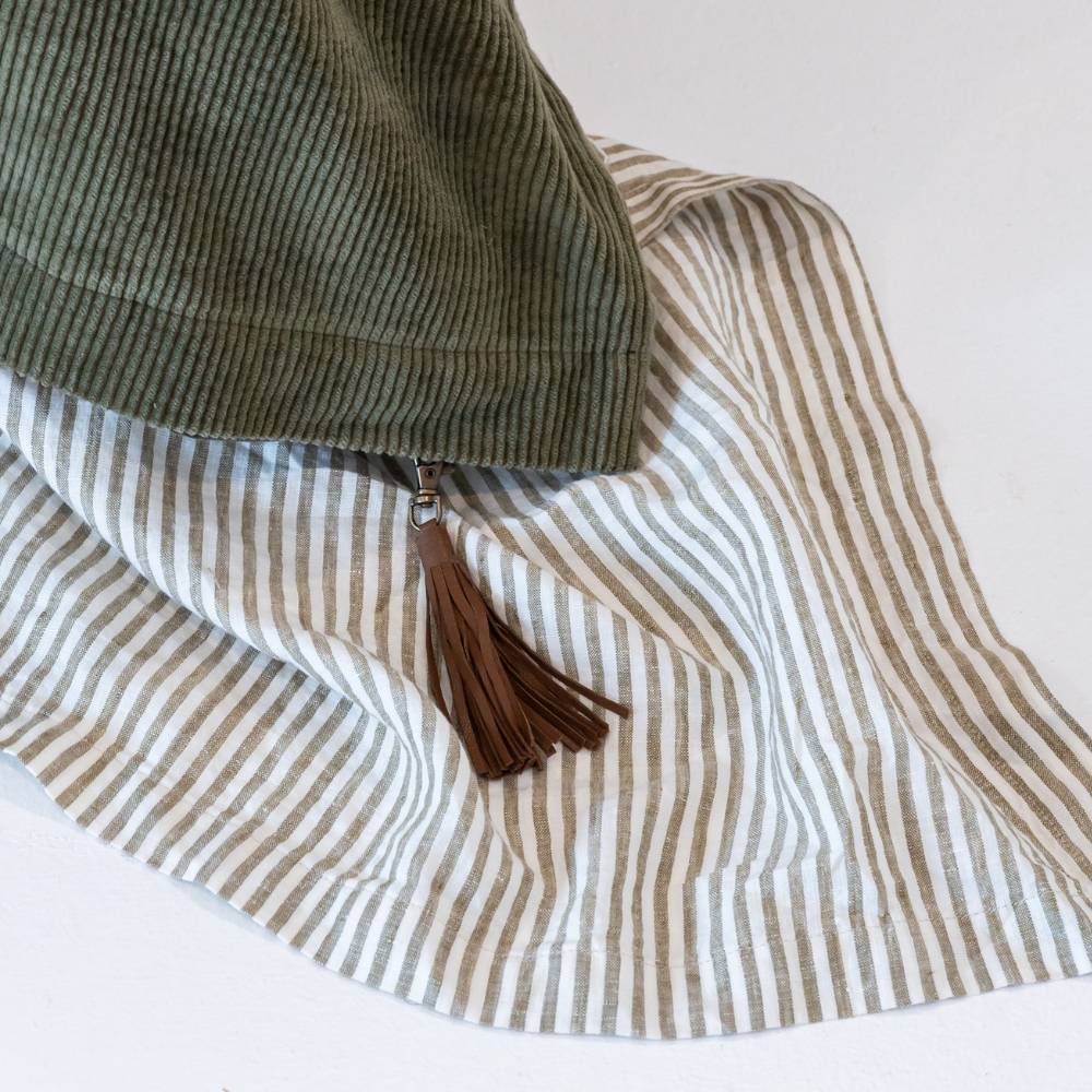 Striped fabric with a tassel on a white background