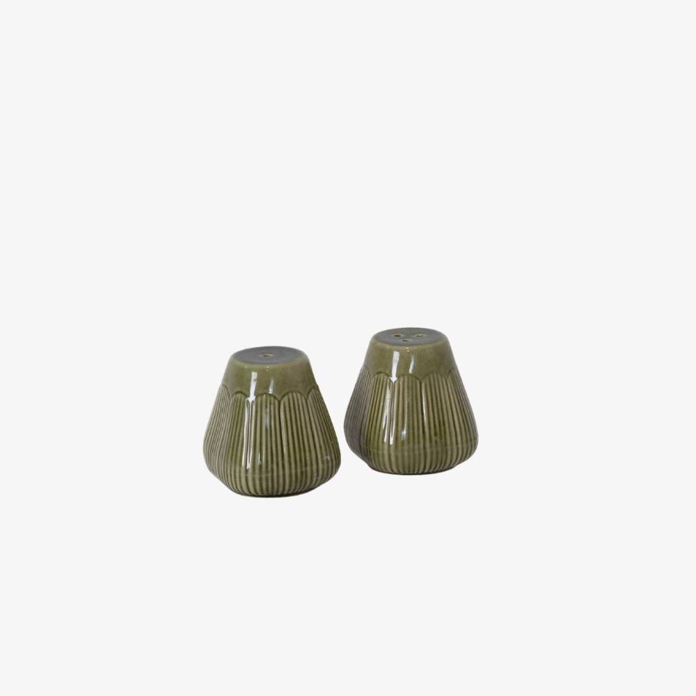 Two green ceramic salt and pepper shakers on a white background