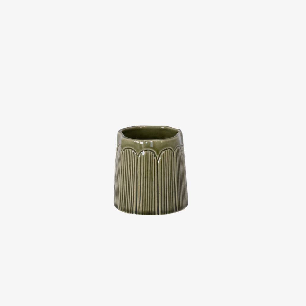 Green ceramic planter with ribbed texture on a white background