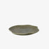 Green ceramic plate with textured design on a white background