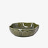 Green ceramic bowl with textured design on a white background