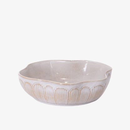 White ceramic bowl with decorative patterns on a white background