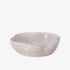 White ceramic bowl with decorative patterns on a white background