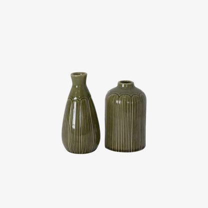 Two green ceramic vases on a white background