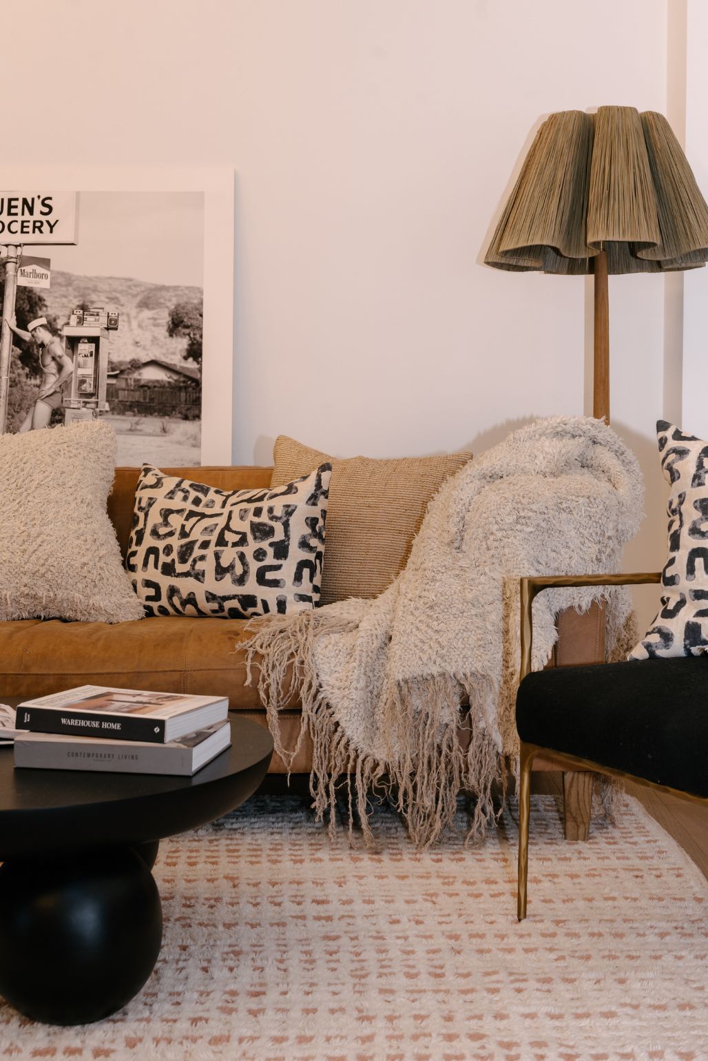 Living room with a couch, coffee table, and linen cushions and textured natural fibre throw rug.