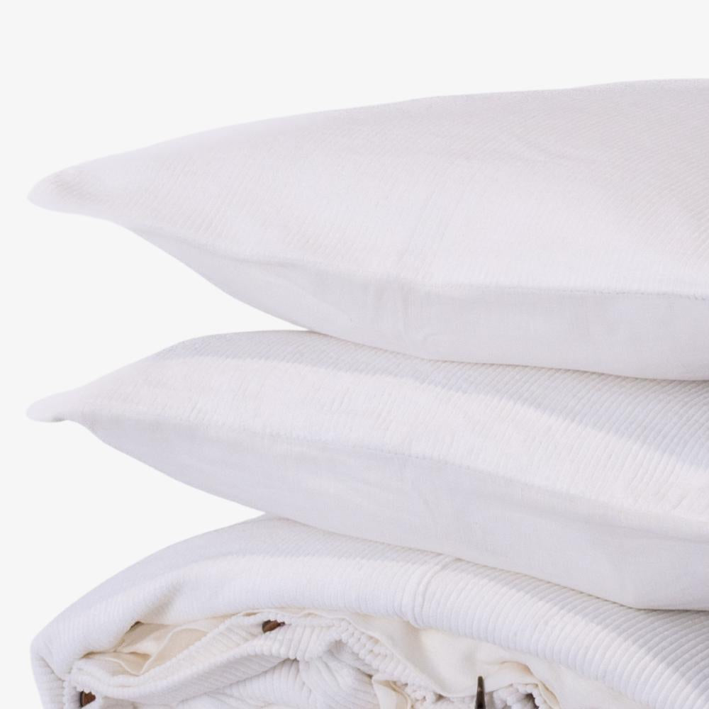 Stack of white pillows on a white background