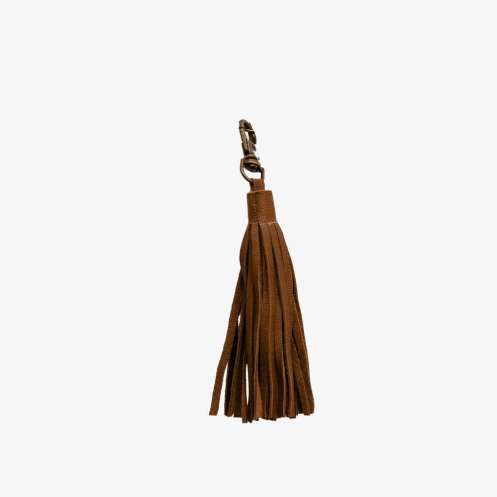 Brown leather tassel keychain on a white background