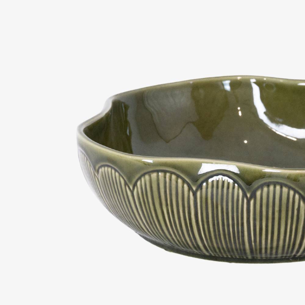 Green ceramic bowl with decorative edge on a white background