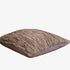 Textured brown cushion on a white background