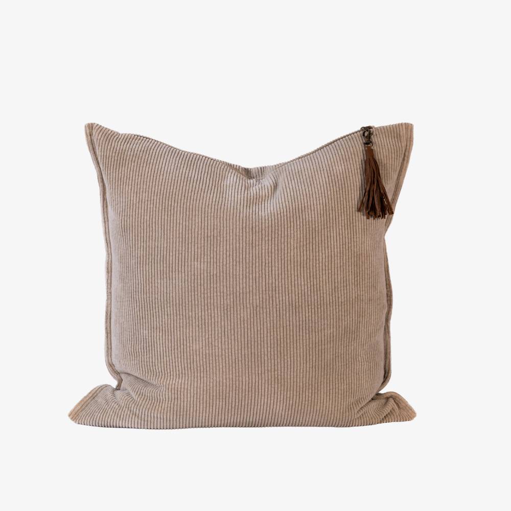Beige pillow with a tassel on a white background