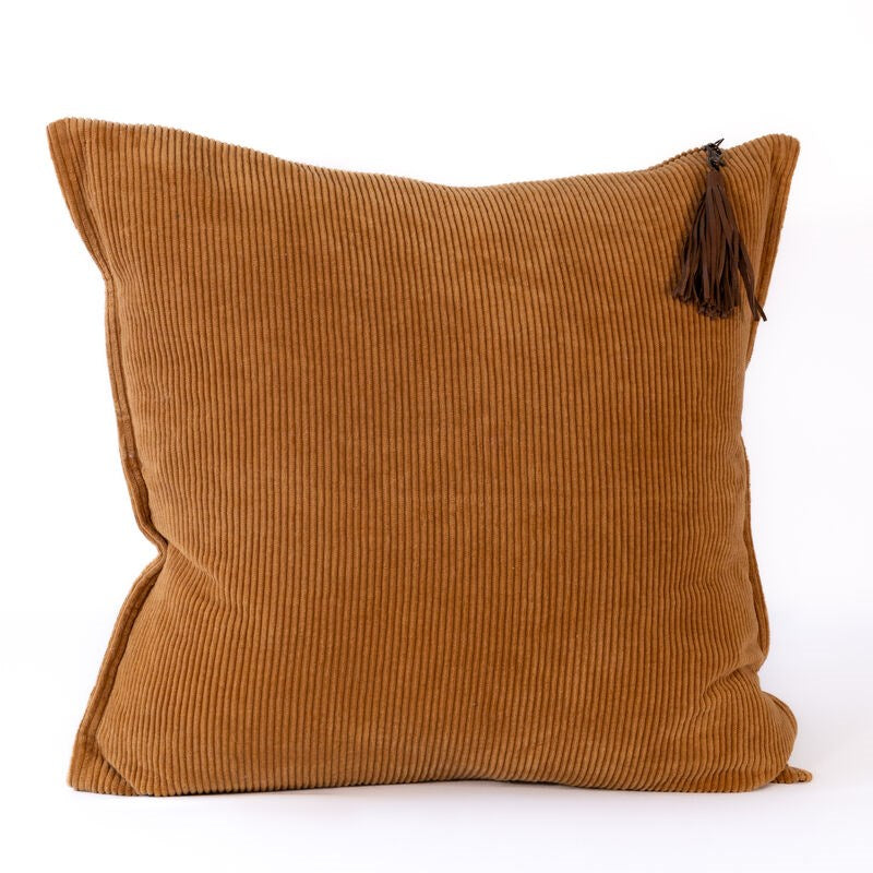 Brown corduroy pillow with a tassel on a white background
