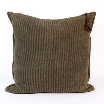 Dark green corduroy pillow with a tassel on a white background