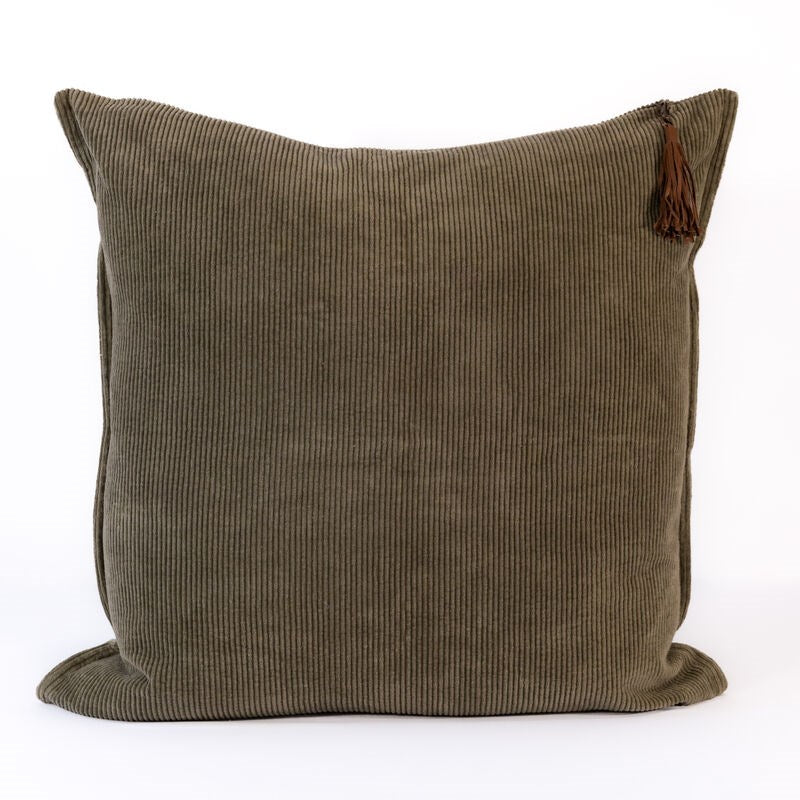 Dark green corduroy pillow with a tassel on a white background