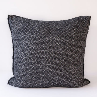 Textured dark gray pillow on a white background