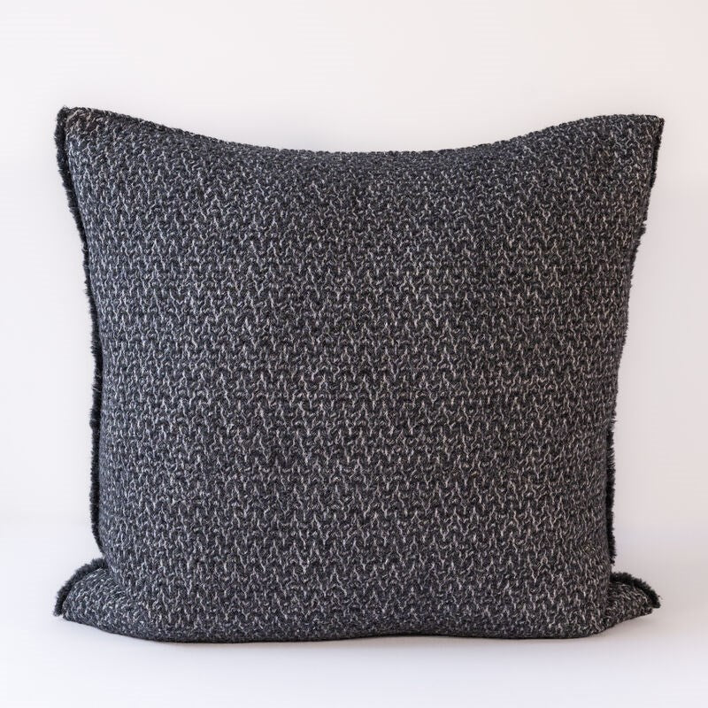 Textured dark gray pillow on a white background