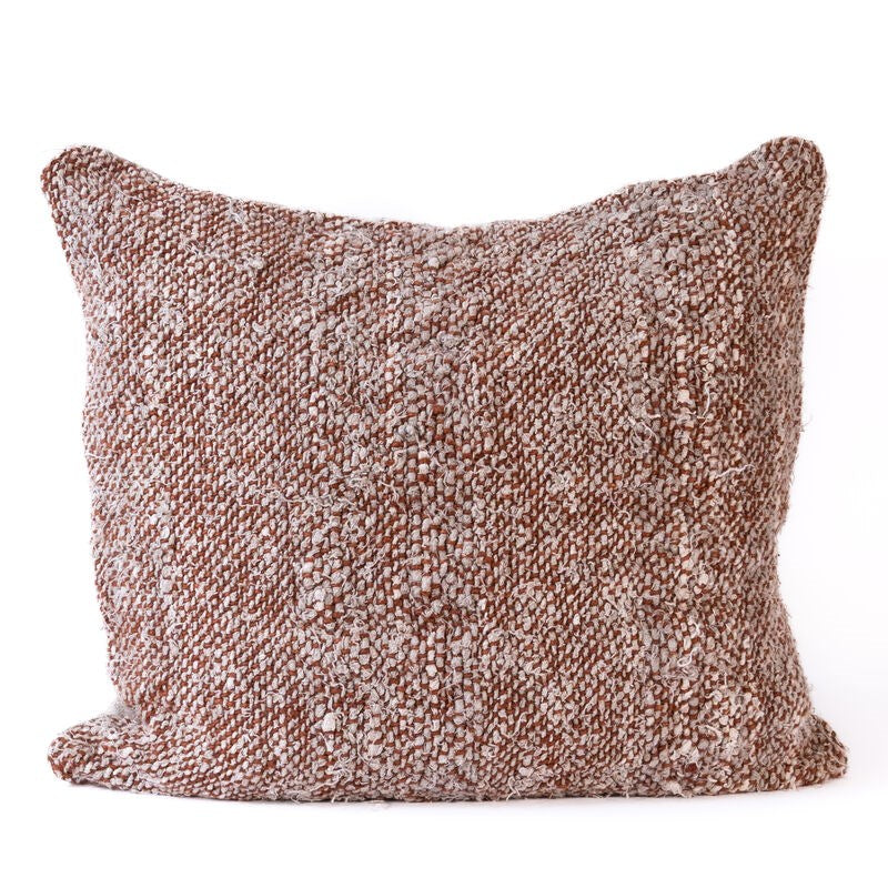 Textured brown pillow on a white background